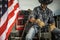 Cowboy Rancher Seating on His Pickup Truck Cargo Bed with a Rope in His Hands