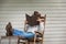 Cowboy Relaxing on Porch in Rocking Chair