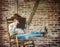 Cowboy Relaxing on Rustic Porch in Rocking Chair