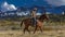 Cowboy rides horse across historic Last Dollar Ranch on Hastings