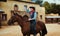 Cowboy riding a horse in texas country, saloon