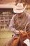 Cowboy roping calves on a cattle ranch