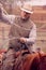 Cowboy roping calves on a cattle ranch