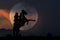 Cowboy silhouette on horseback with moon