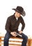 Cowboy sitting holding a gun