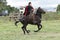 cowboy throwing a lasso from horse back