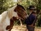 Cowboy touches the horse with love