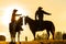 Cowboys on horses at sunrise, British Colombia, Canada