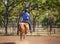 Cowgirl Competing In Barrel Racing Competition At Country Rodeo