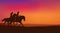 Cowgirl and cowboy riding horses in romantic sunset background