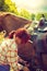 Cowgirl getting horse ready for ride on countryside