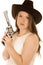 Cowgirl holding revolver with serious facial expression looking