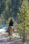 Cowgirl horseback riding in forest