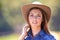 Cowgirl, portrait and hat at farm, nature and western fashion for agriculture, work and outdoor in summer. Woman, person