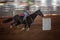 Cowgirl Rides Horse At Speed In Rodeo Barrel Racing Competition