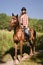 Cowgirl riding a bay horse