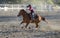 Cowgirls competing in barrel riding