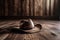 cowhide rug on wooden floor with cowboy hat and rope in the background