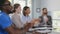 Coworkers applauding celebrating business success sitting at desk during corporate meeting in office