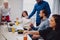 Coworkers discussing and having lunch in the office