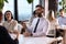 Coworkers having coffee break near window