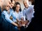 Coworkers Holding Hands During Teambuilding Meeting In Modern Office