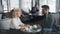 Coworkers man and woman speaking in cafe during lunch break talking gesturing