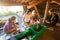 Coworkers Preparing Food In Shed At Forest