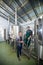 Coworkers standing by storage tank at brewery