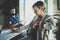 Coworkers working process at home.Young blonde woman working together with bearded colleague man at modern home office