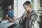 Coworkers working process at home.Young blonde woman working together with bearded colleague man at modern home office