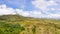 Cows graze in the mountain meadows. Beautiful landscape on the island of Luzon, aerial view. Green hills and mountains.