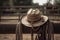 cowwboy hat and rope hanging from saddle of galloping cowboy