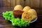 Coxinha in the dish, traditional Brazilian cuisine snacks stuffed with chicken, on rustic wooden table