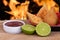 Coxinha. Traditional fried brazilian food with chicken. Background with defocused fire