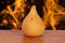 Coxinha. Traditional fried brazilian food with chicken. Background with defocused fire. Space copy