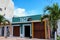 Cozumel/Mexico -Mar 22, 2016: Mexican man repairing something on the roof. Old traditional street with colorful buildings in