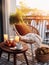 Cozy autumn balcony decor, warm fall city balcony decor with chair and pillows, pumpkins, yellow leaves and candles