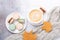 Cozy autumn composition with sweater, coffee, various macaron and yellow maple leaves on stone background. Flat lay, top view