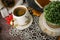 Cozy autumn still life with cup of hot black coffee. knitted hat and scarf on wooden background