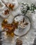 Cozy autumn still life - hot chocolate with marshmallows, garland, maple leaves, soft slippers on a fluffy carpet, top view