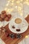Cozy autumn or winter concept. Cup of coffee with a garland lights and decoration