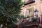 Cozy balcony with house plants in downtown district of Madrid, Spain. Vintage urban architecture