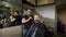 Cozy Barbershop, is engaged in a professional stylist haircut men aged. A respectable businessman in the client\'s chair