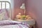 Cozy bedroom interior with decorative sheep dolls and reading lamp