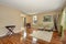 Cozy beige sitting room with shiny hardwood floor and dining area