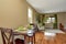 Cozy beige sitting room with shiny hardwood floor and dining area