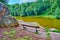 The cozy bench on the rocky bank of Ionian Sea lake in Sofiyivsky Park, Uman, Ukraine