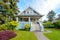 Cozy blue house with a beautiful garden on a sunny day