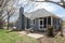 Cozy blue residential home with a patio and an enclosed deck area